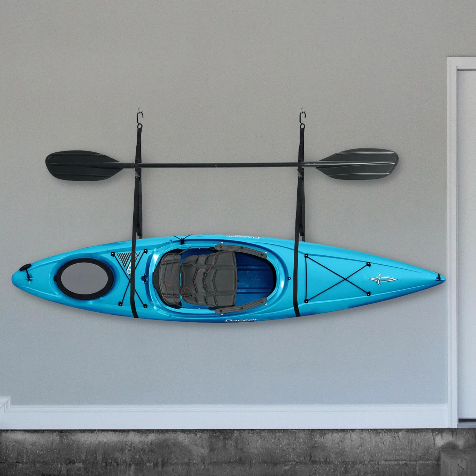 A kayak and paddles in the storage straps